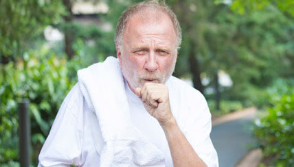 man coughing into his hand
