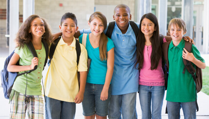 group of middle school students smiling together