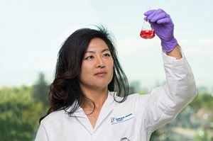 Scientist with liquid lab results
