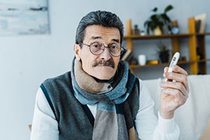 older man with thermometer