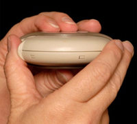 Place the thumb of the other hand on the thumb grip.