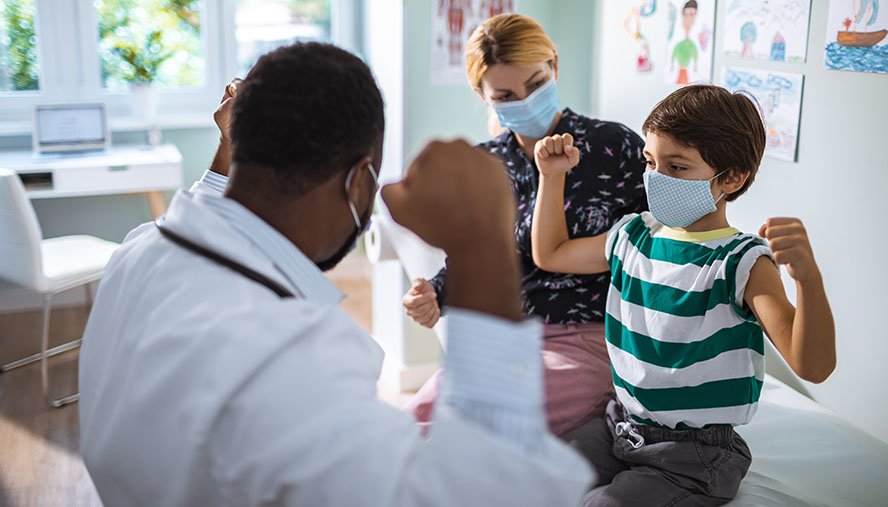 Doctor, Patient and Monther flexing arms while wearing masks