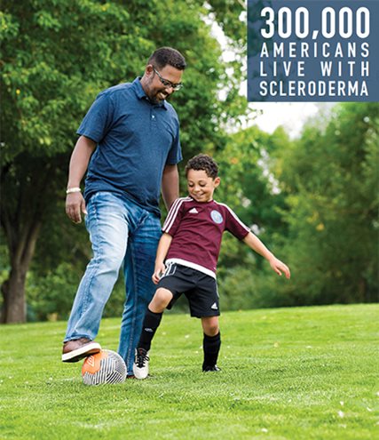 Son and father playing soccer