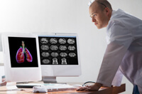 Doctor reviewing lung images on computer