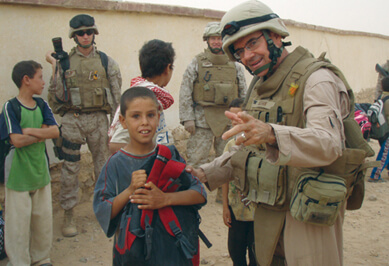 Richard Meehan, MD, served for seven months in Iraq with the U.S. Navy. Community Medical Engagements, such as the one above, were conducted to provide local medical care and promote good will between Iraqis and Coalition Forces.