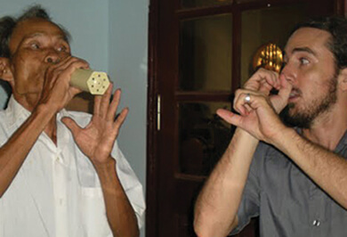 Joshua Solomon, MD, (right) established a mobile clinic in rural Vietnam to care for patients, and works to educate local doctors to improve their skills.