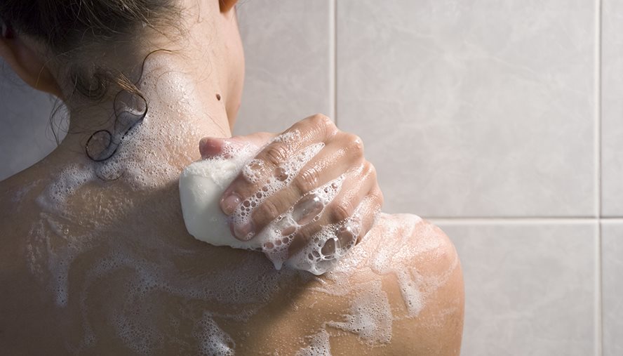Person washing their body with soap