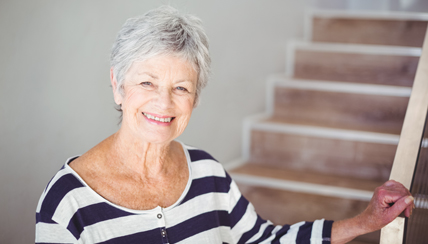 woman smiling by her staircase