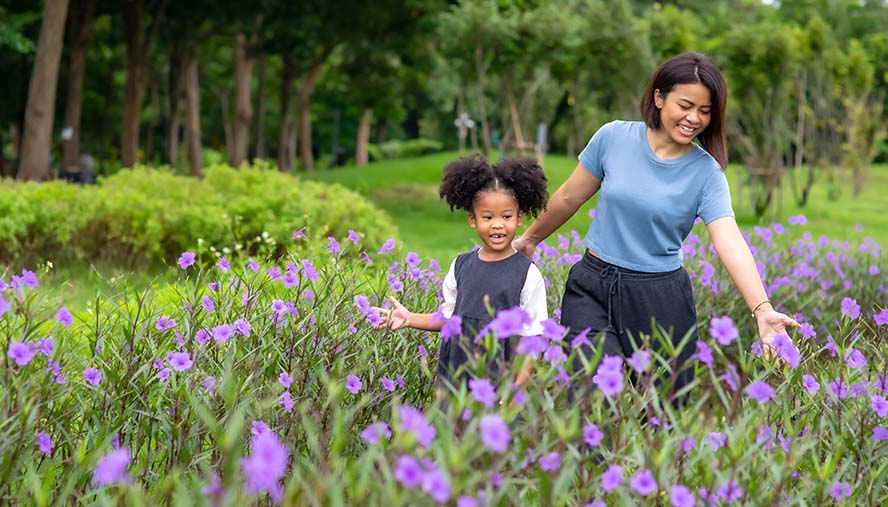 Mother and daughter in field of flowers, pediatric allergy