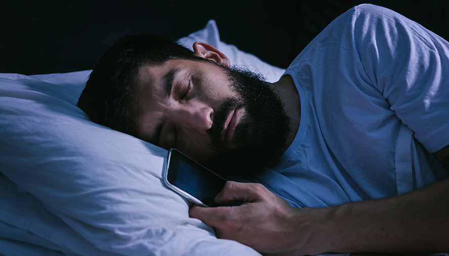 Man sleeping with phone in hand
