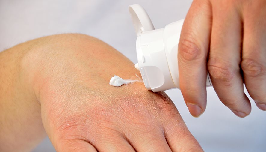 Person applying lotion to their hands
