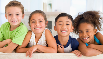 group of four children smiling