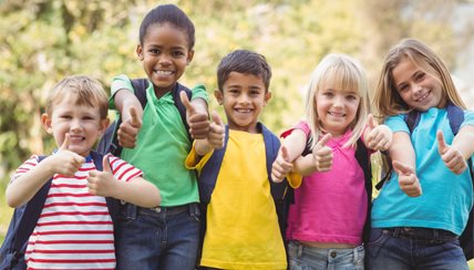 Kids holding their hands up with their thumbs in the air