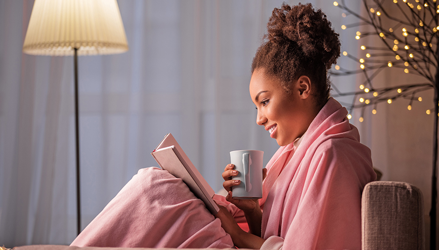 Woman reading a book in a chair