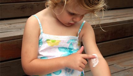 young girl applying cream