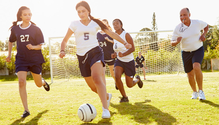 group of young women playing soccer