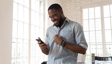 middle-aged man laughing at mobile phone image
