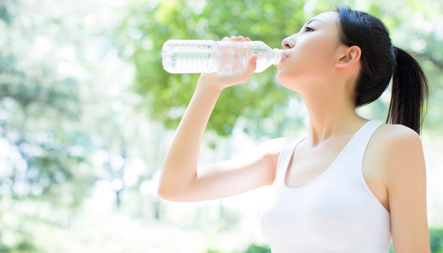 Woman drinking water outside