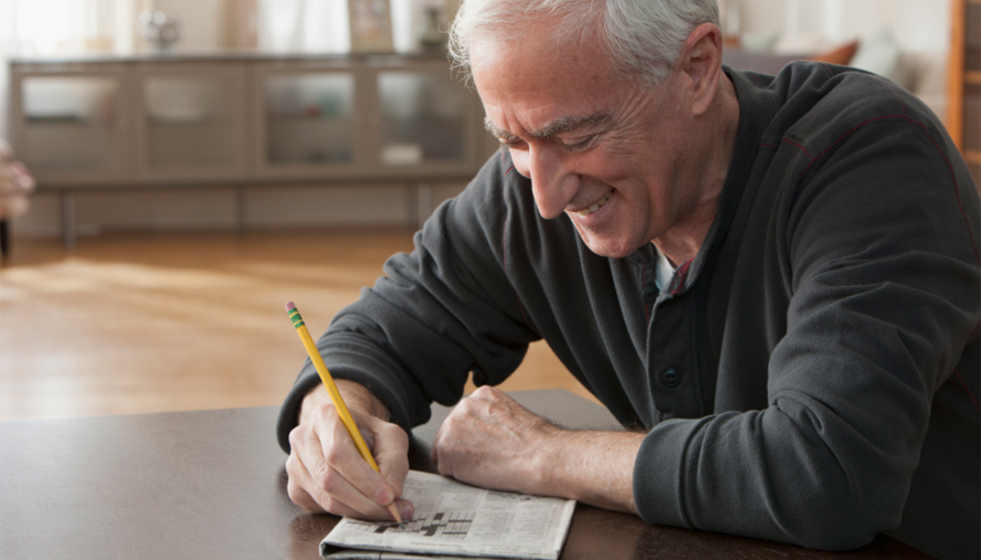 Man doing crossword puzzle for mental health