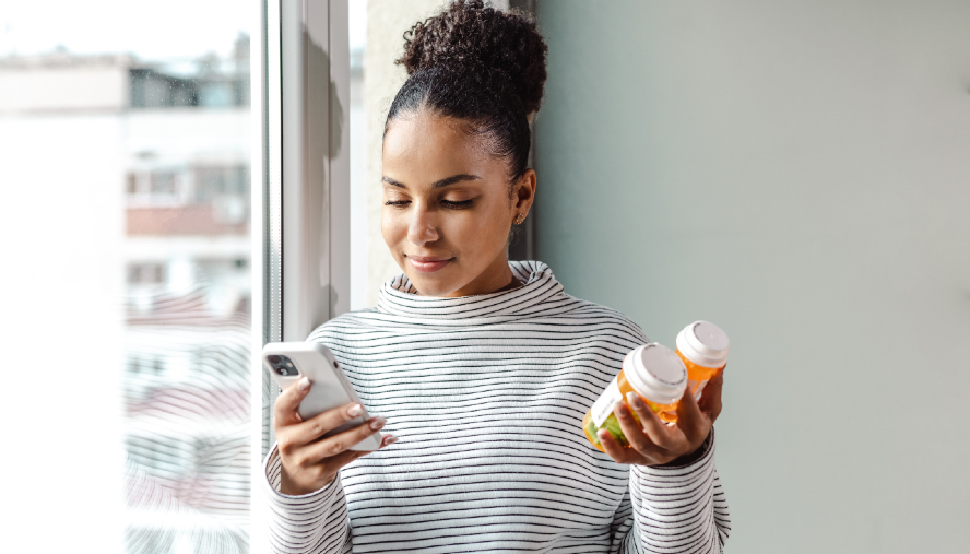 Woman holding medications and reviewing directions