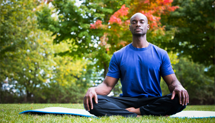 man meditating in the park