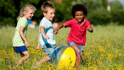 children playing with a ball in a field