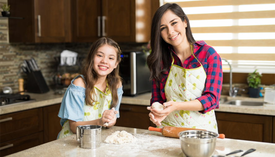 Mother and daughter baking together