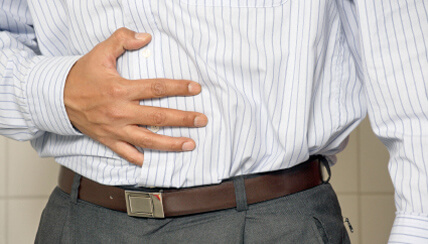 man clutching stomach in distress man clutching stomach in distress