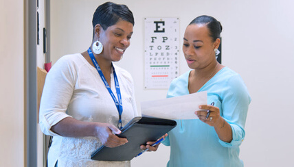 doctor and nurse conferring over a patient's chart