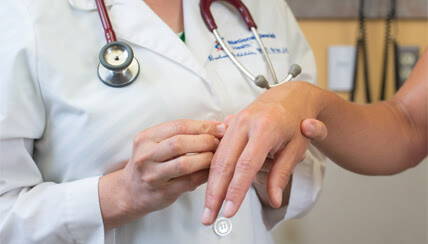 Physician treating patient's hand