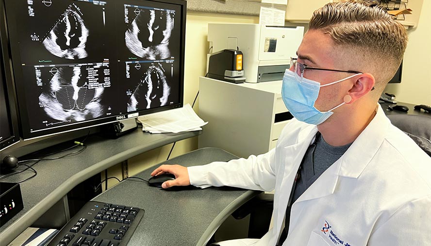 Chris Fine, MD, reviews echocardiogram images at National Jewish Health. Dr. Fine is a cardio-oncologist, an emerging specialty that works closely with a patient’s cancer team to reduce the risk of cardiac events, protect their heart health throughout treatment and monitor their risks after remission.