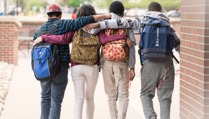 students at Morgridge Academy with arms slung over each other's shoulders