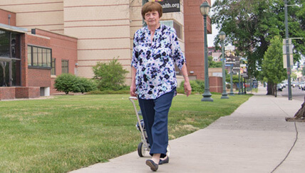 Woman walking with oxygen tank