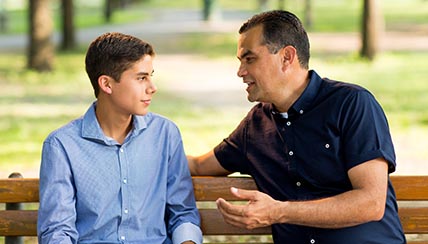 father and son on park bench