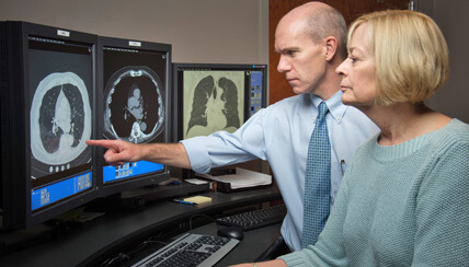 Radiologist physicians reviewing brain scans