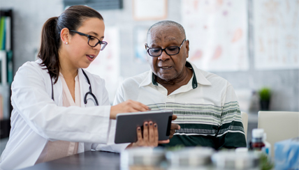 Physician and patient reviewing pricing