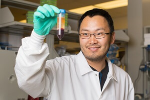 beryllium lab researcher holding sample