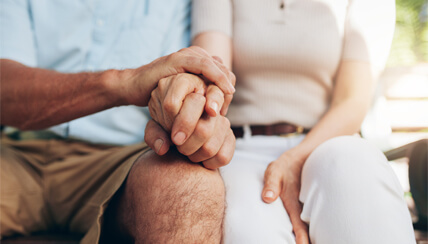 two seniors holding hands