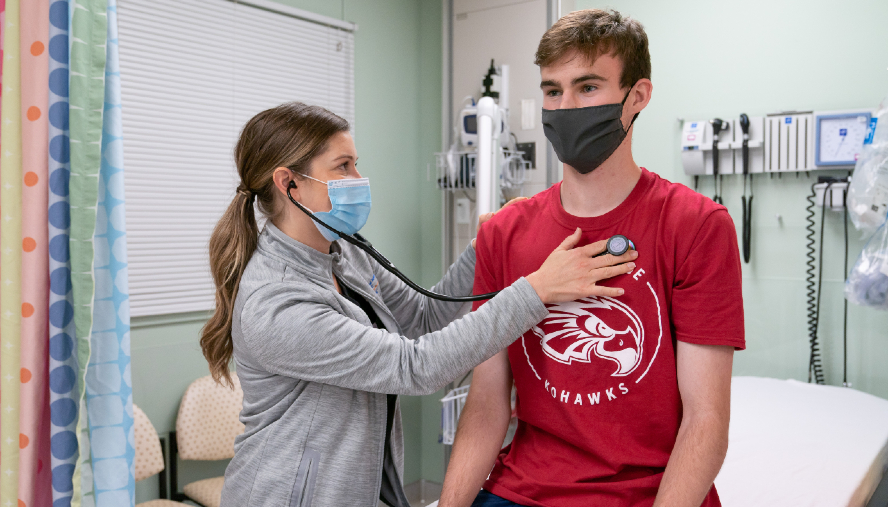 Ian Kearney receiving a checkup from a nurse