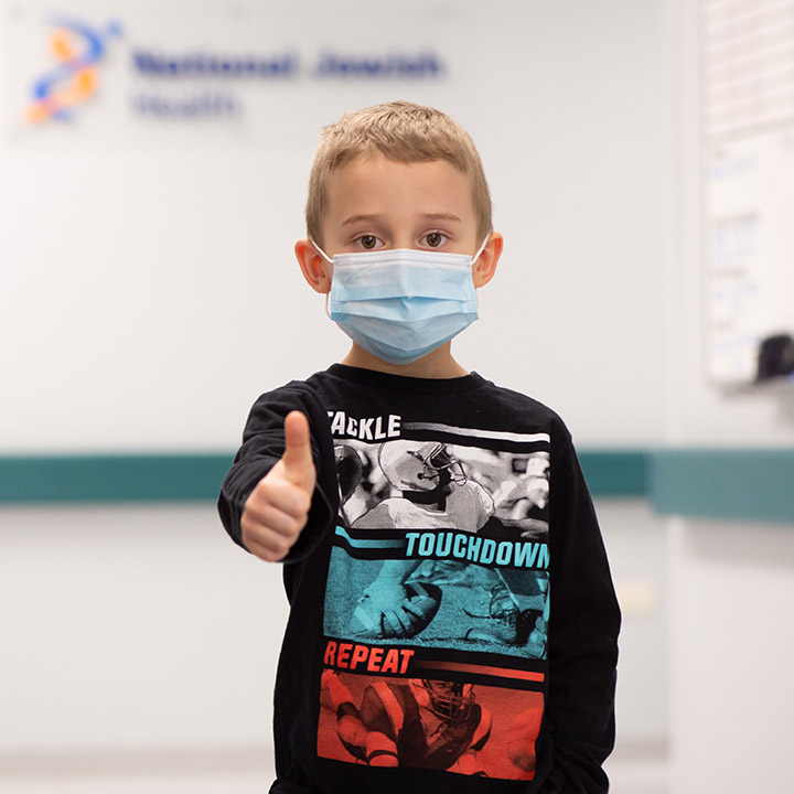 Child giving a thumbs up