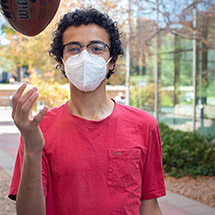 Mouhamed tossing a football