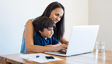 mother and son reviewing info on laptop