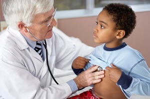 doctor listening to child's breathing