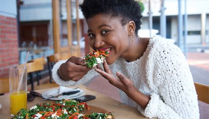 woman eating pizza